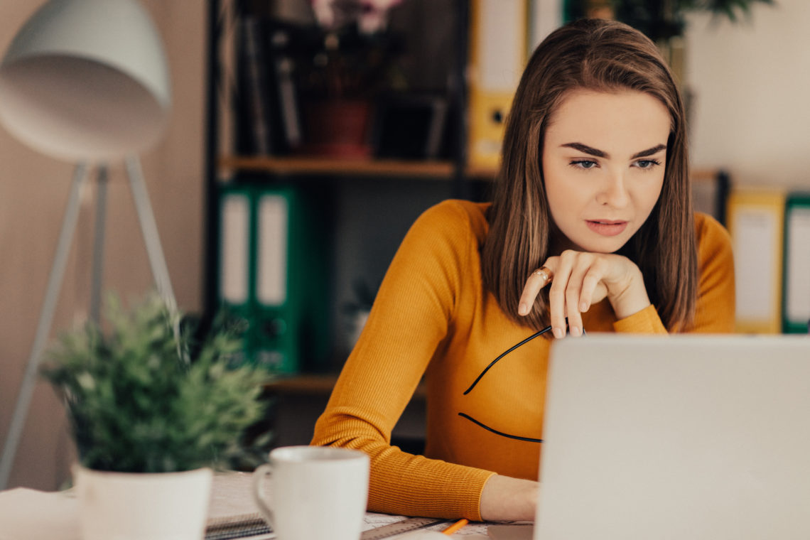 Beautiful girl in the office using laptop