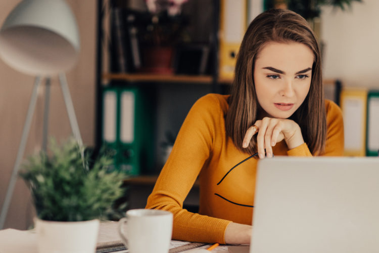 Beautiful girl in the office using laptop